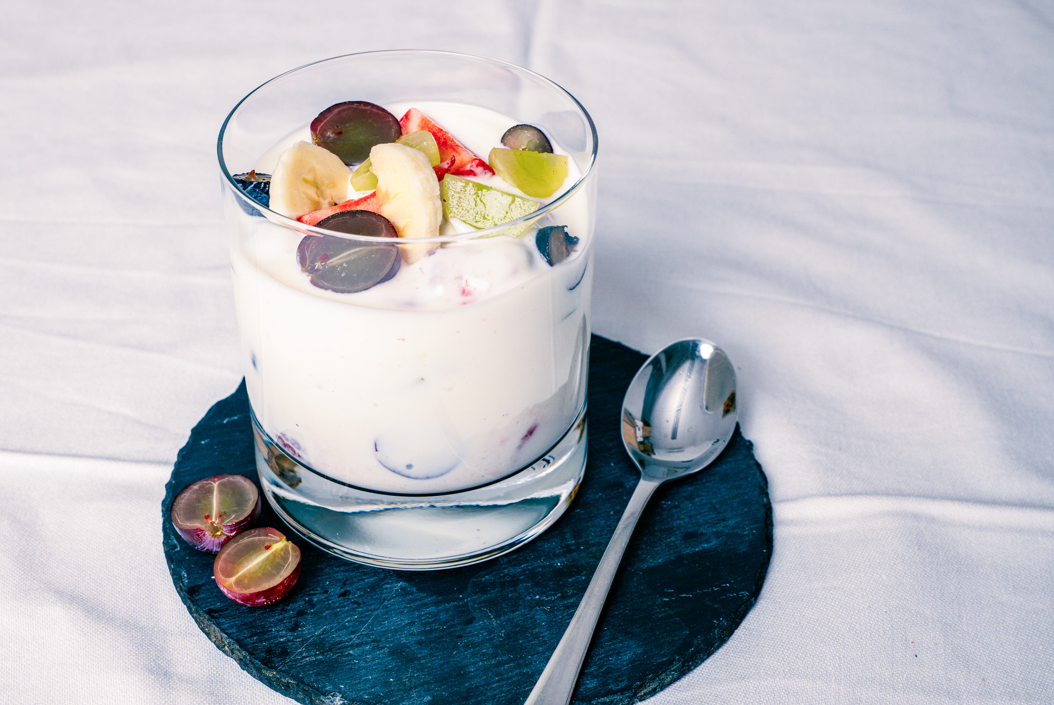 Abbildung von Fruchtjoghurt im Glas mit Löffel